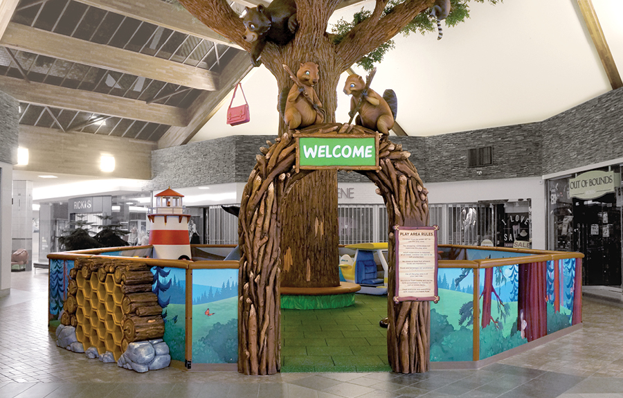 Mall play area with a custom sculpted enclosure, forest animals, and woodland theming