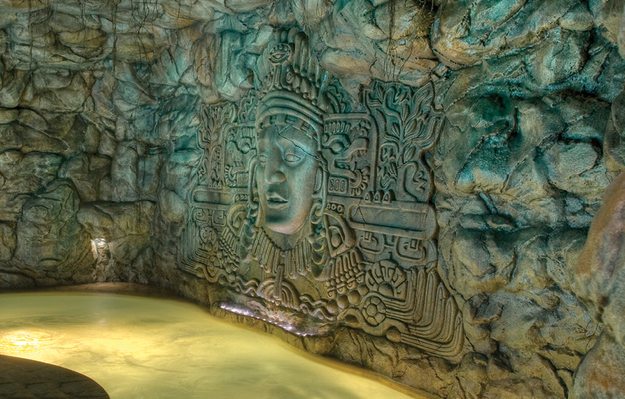 Aztec themed waterpark attraction with sculpted reliefs and stone wall cladding