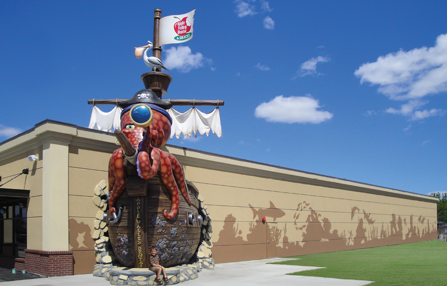 Pirate octopus character with pirate ship as an office exterior landmark