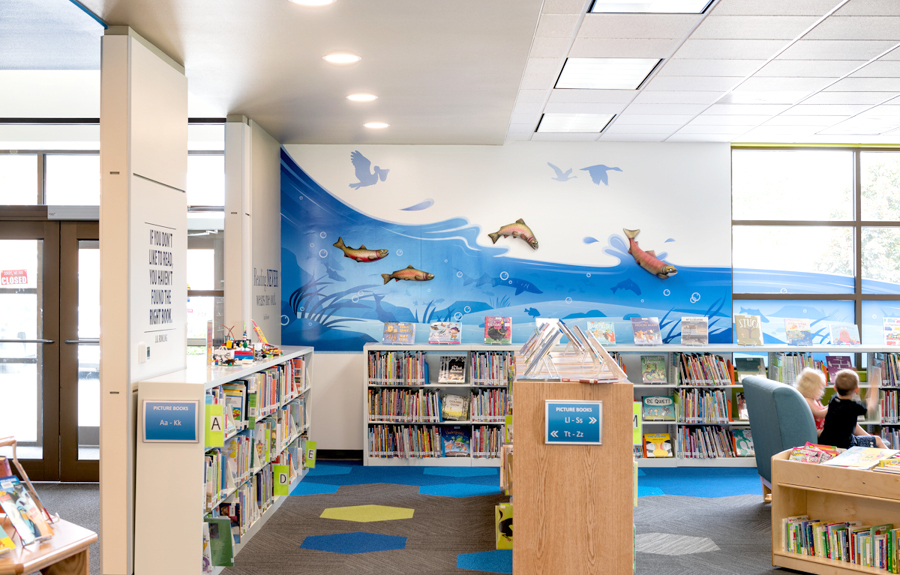 Library decorated with stylish wall river mural and sculptures of fish