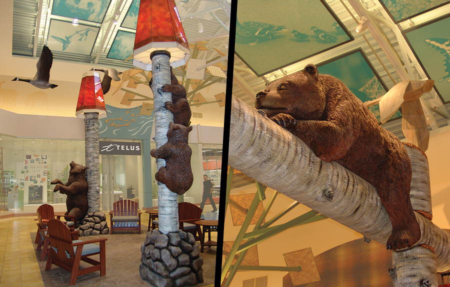 Mall seating area with nature themed décor featuring sculpted bears, trees and flying geese