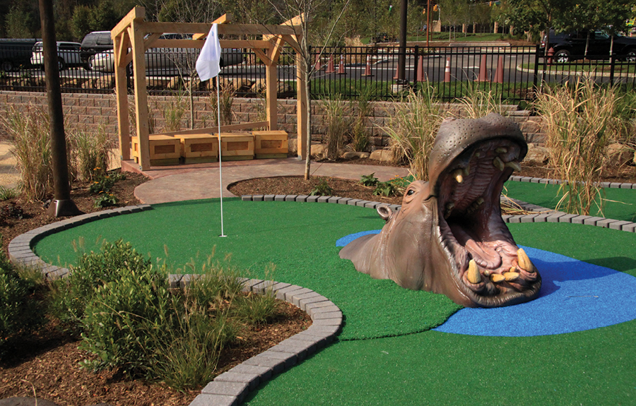 Mini golf course decorated with a realistic foam hippo