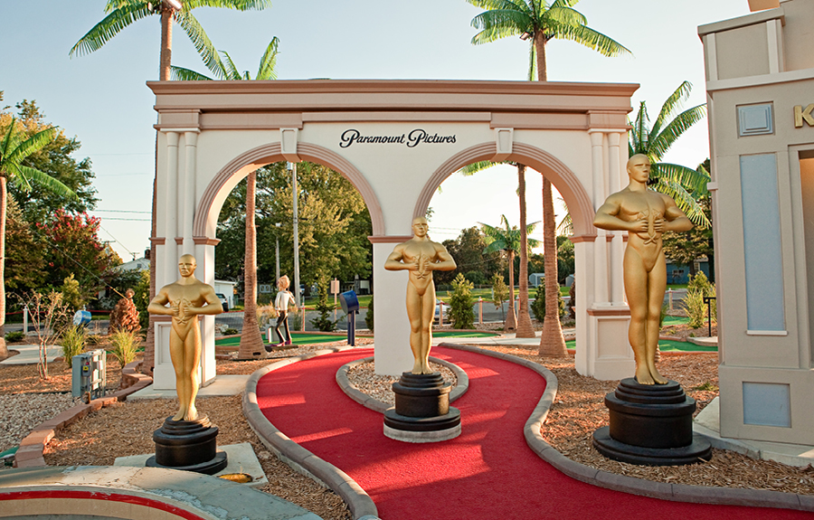 Giant foam academy award trophies in a movie themed mini golf course