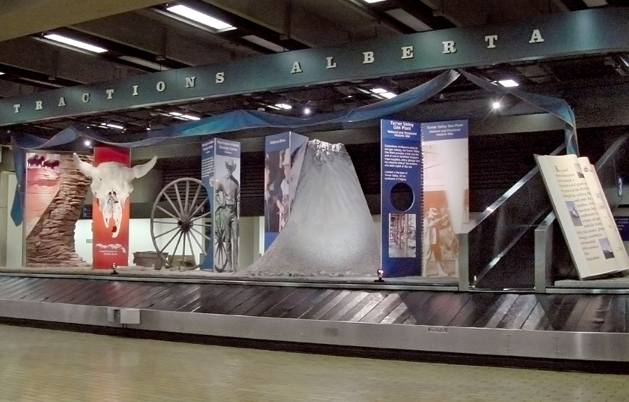 Western themed sculpted foam displays in an airport exhibit about the history of Alberta
