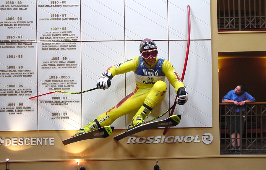 Oversized realistic 3D foam sculpture of a slalom skier in a sports history museum