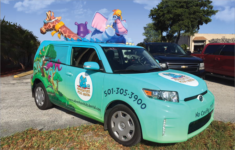 Vinyl vehicle wrap with custom promotional art and sculpted roof animal mascots
