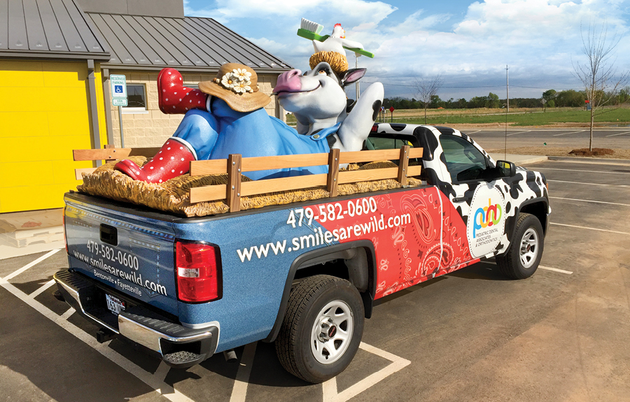 Custom promotional truck wrap with a sculpted cow mascot