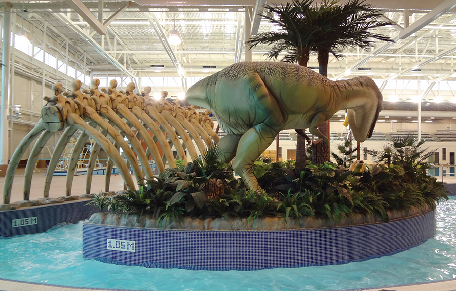 Water park island with a realistic sculpted dinosaur and giant ribcage fossil