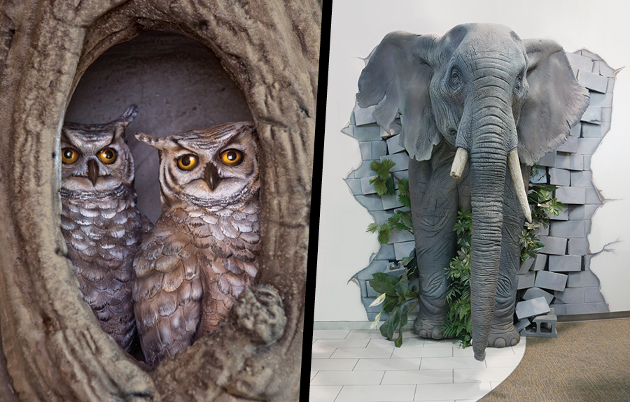Foam sculptures of owls in a tree hole and an elephant busting out of a wall